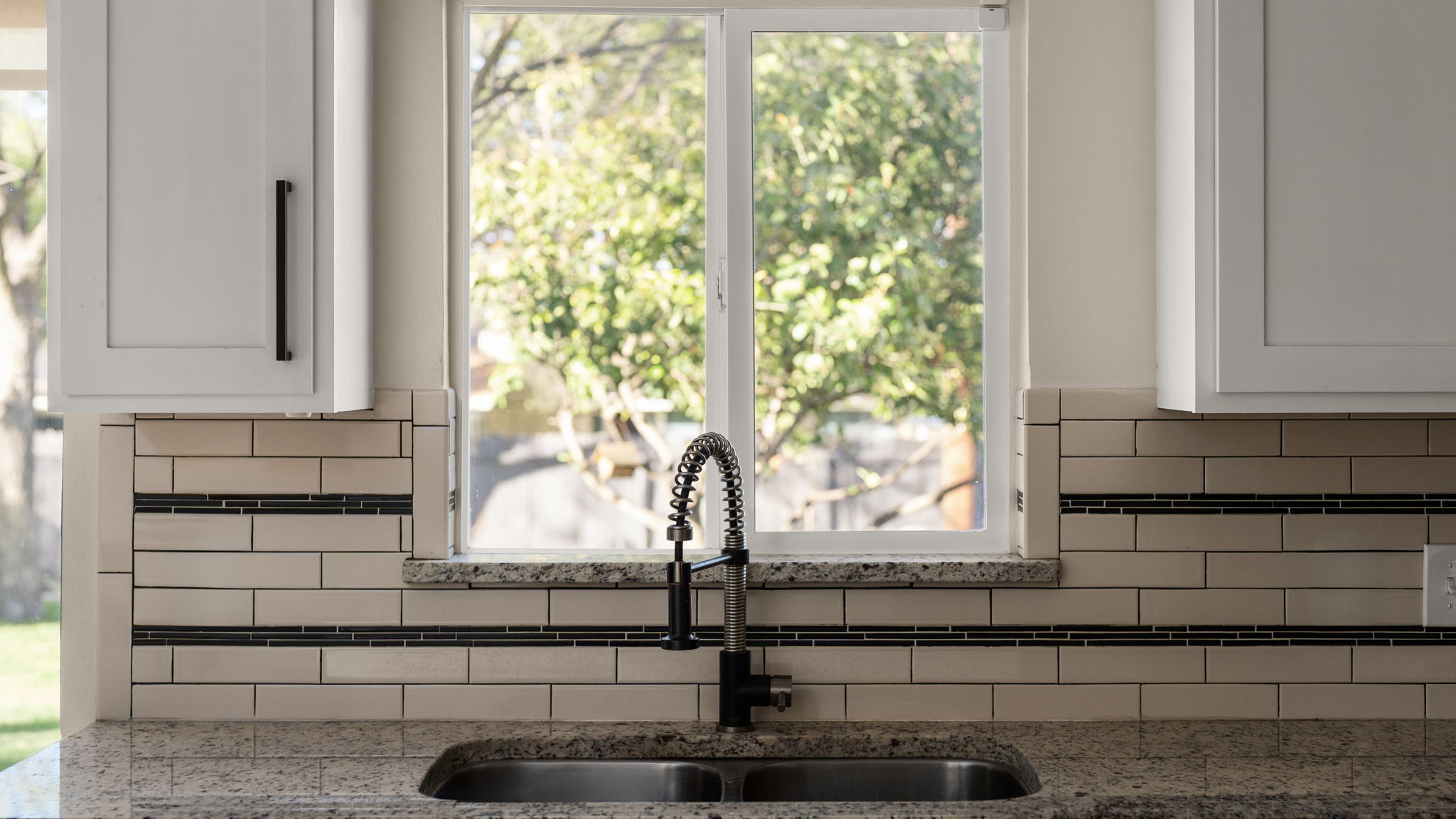 1602 Thornridge Road Austin, TX 78758 - Photo 23 of 39 Kitchen view of light stone countertops and white cabinetry