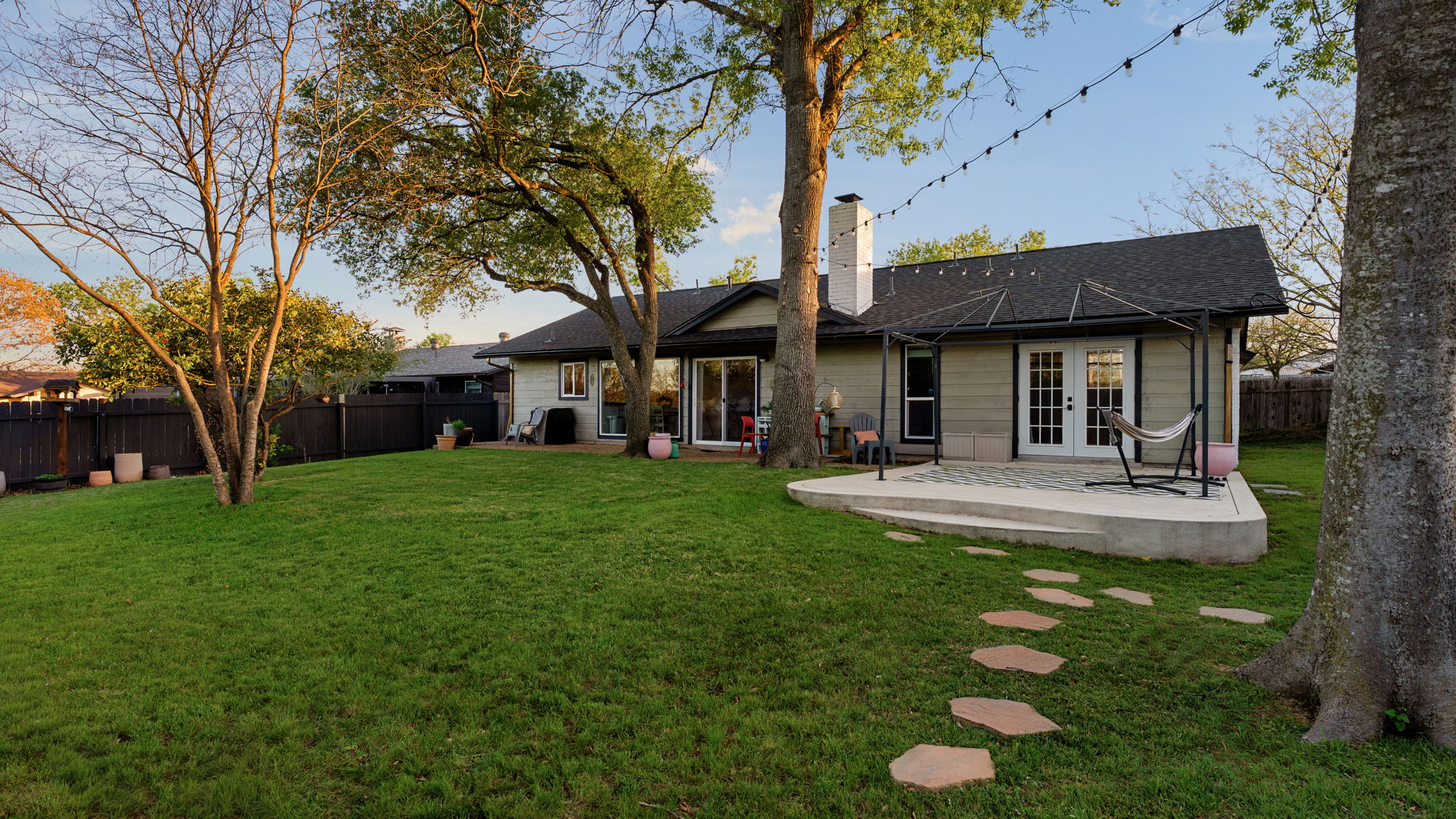 1602 Thornridge Road Austin, TX 78758 - Photo 32 of 39 Rear view of property with a fenced backyard, a chimney, french doors, a patio area, and a shingled roof
