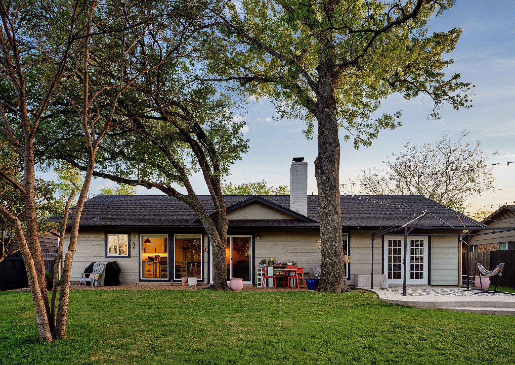 1602 Thornridge Road Austin, TX 78758 - Photo 34 of 39 Rear view of house with a patio and a chimney
