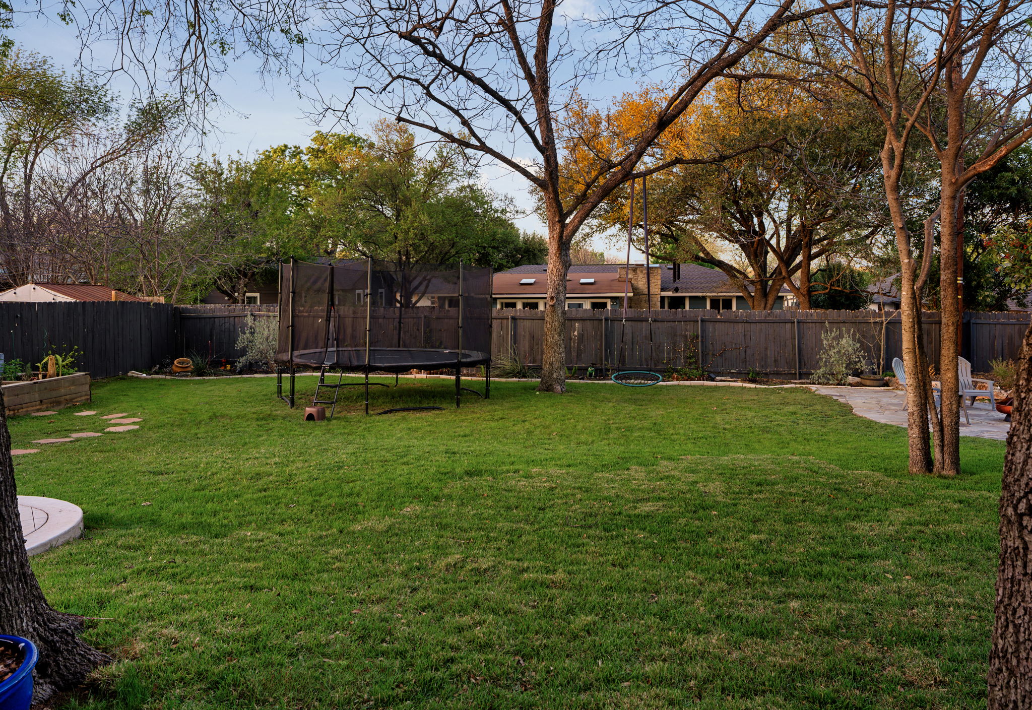 1602 Thornridge Road Austin, TX 78758 - Photo 35 of 39 Fenced backyard featuring a trampoline and a patio
