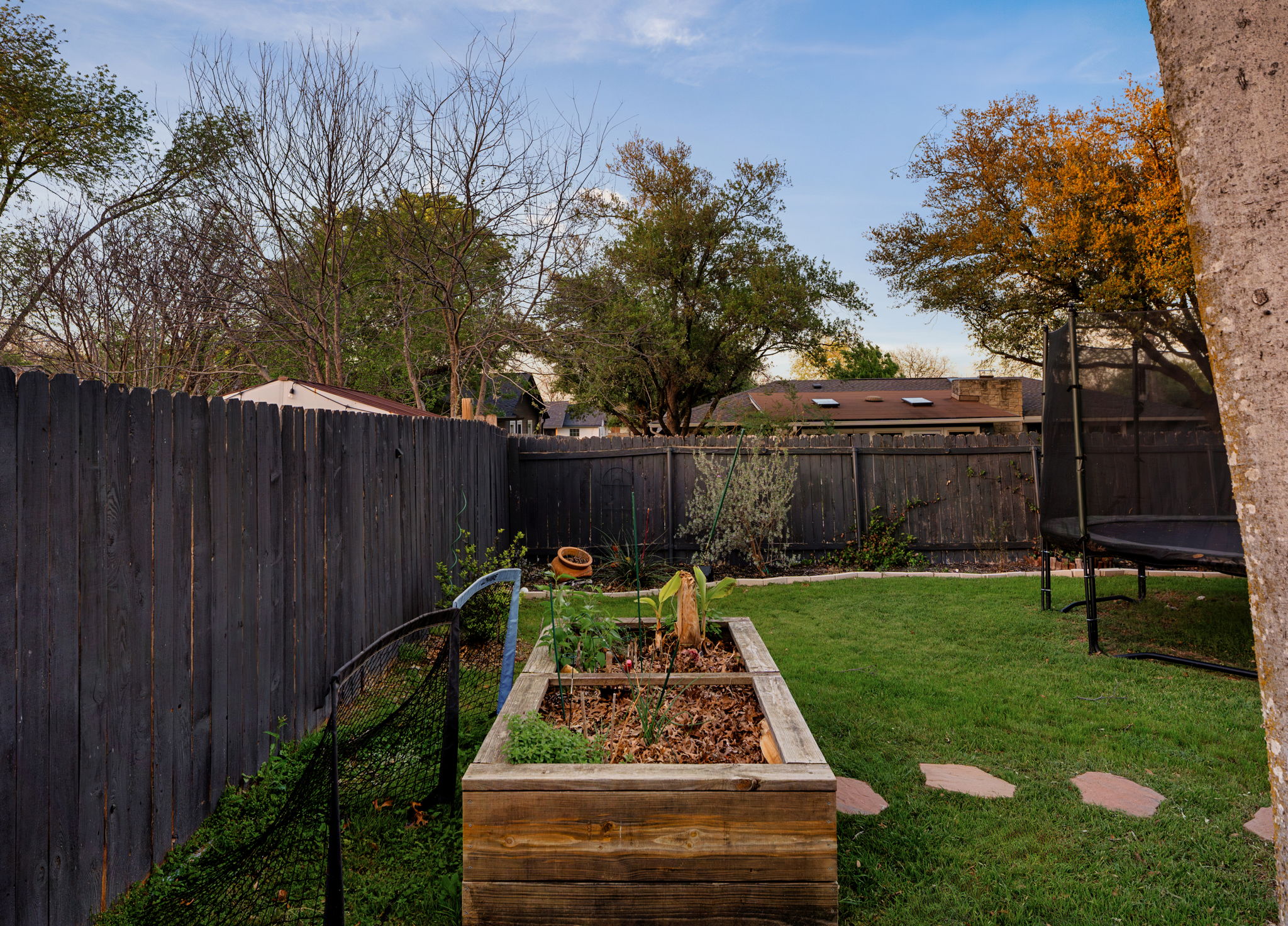1602 Thornridge Road Austin, TX 78758 - Photo 36 of 39 Fenced backyard with a garden and a trampoline