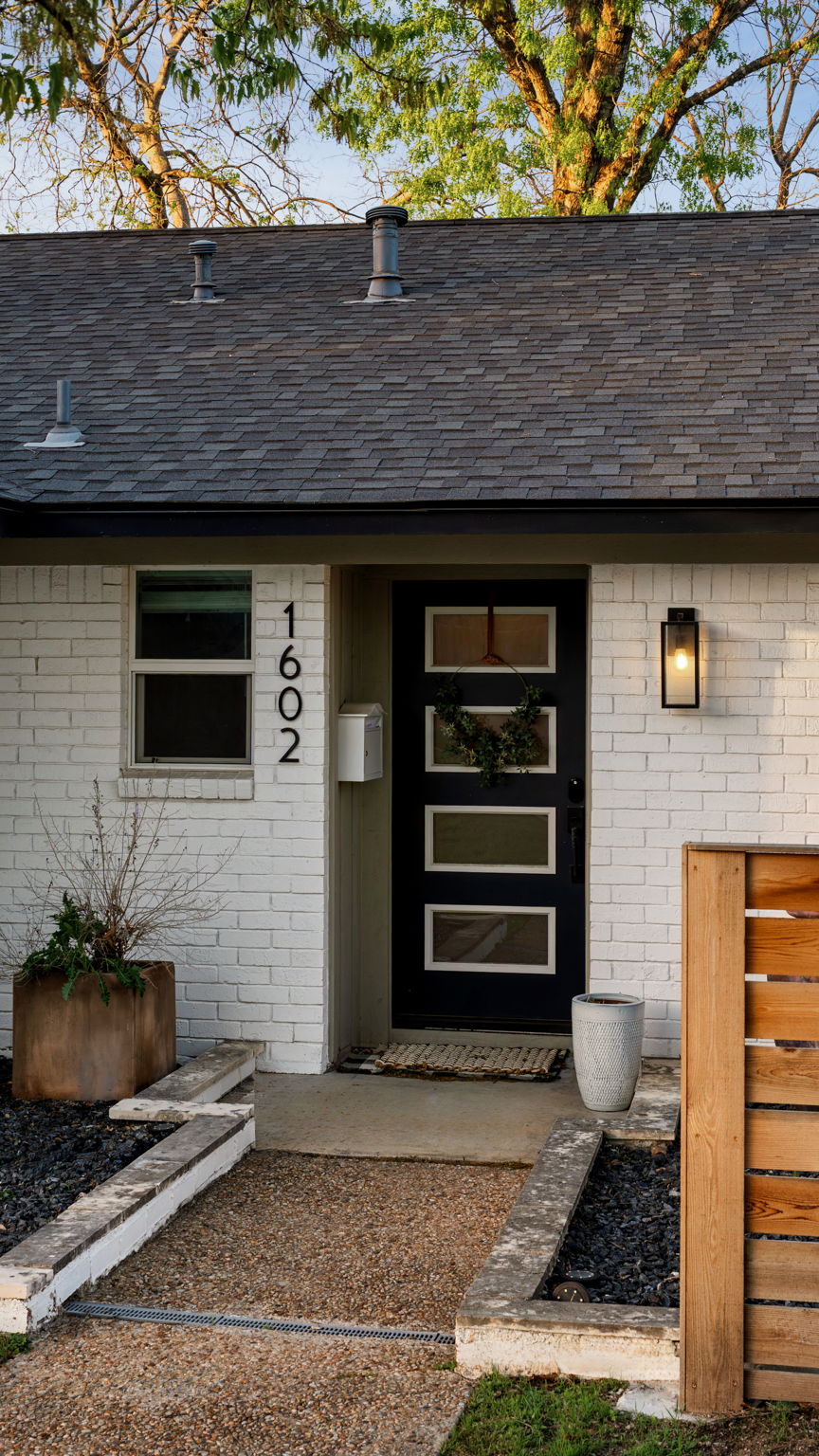 1602 Thornridge Road Austin, TX 78758 - Photo 10 of 39 Entrance to property with brick siding and roof with shingles