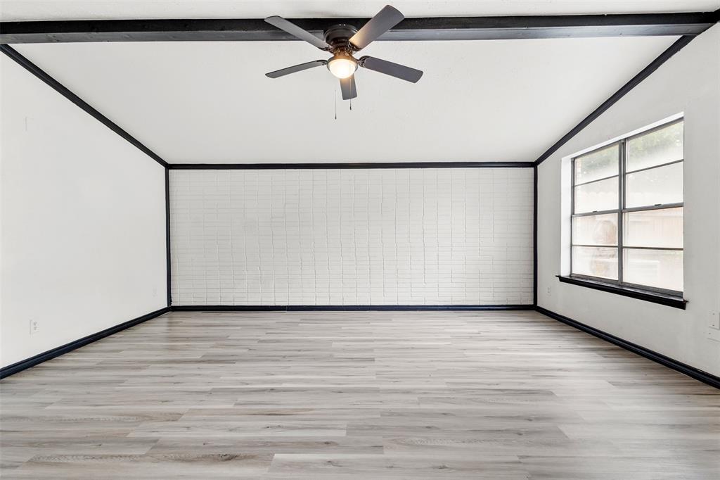 2802 Spring Valley Drive Bedford, TX 76021 - Photo 10 of 24 a view of an empty room with a window and a ceiling fan