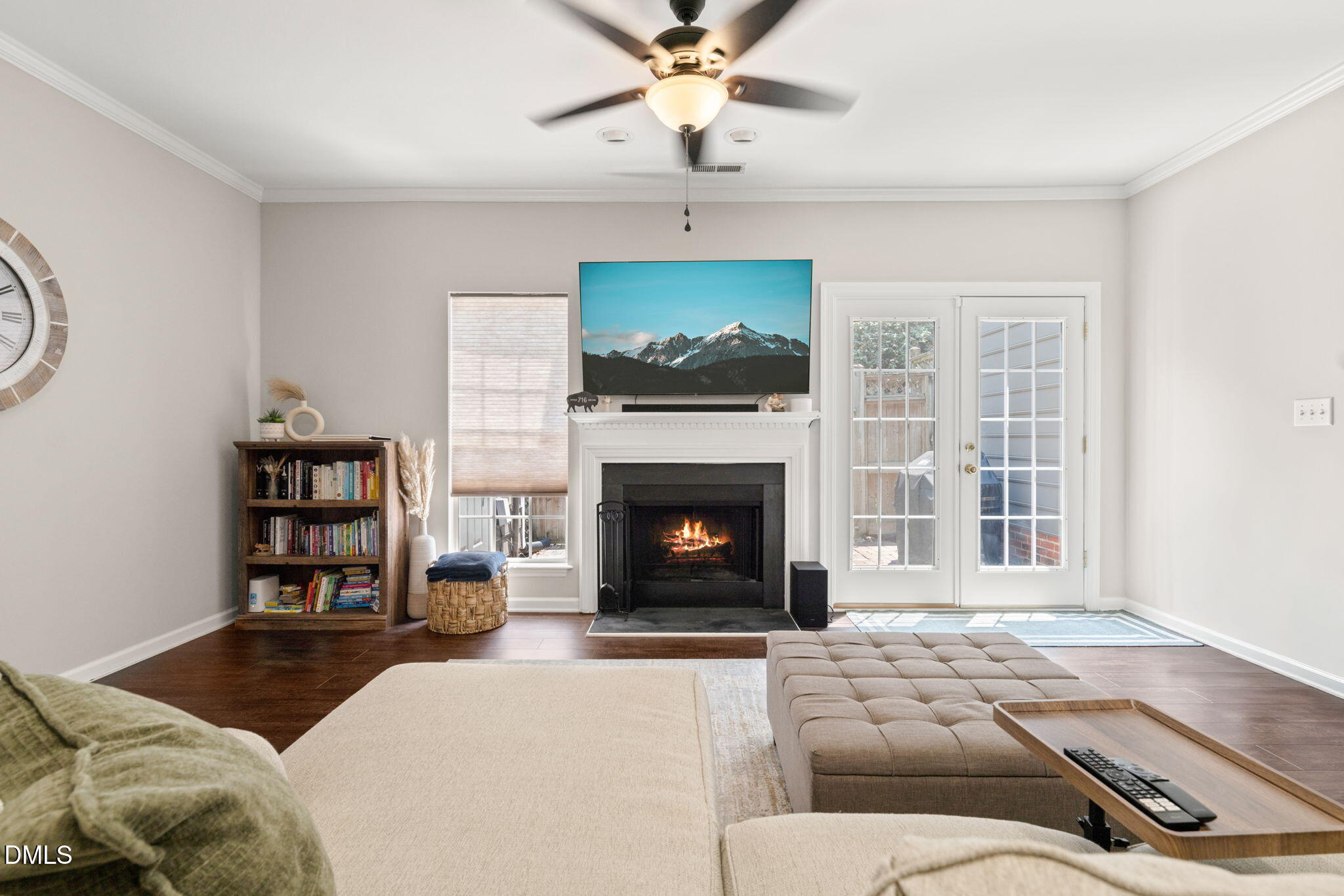 4323 Pine Springs Court Raleigh, NC 27613 - Photo 10 of 38 a living room with furniture a fireplace and a flat screen tv