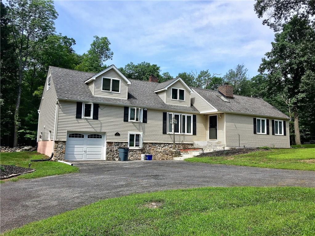 59 Ludlam Road Monroe, NY 10950 - Photo 1 of 1 a front view of a house with a yard and garage