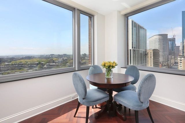 a view of a dining room with furniture and a window