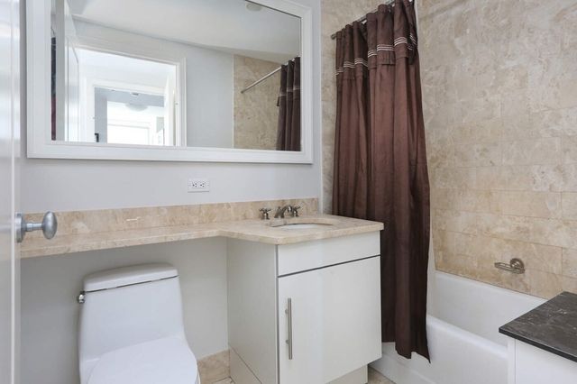 a living room with furniture a chandelier and a large window
