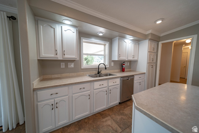 1407 North 1250th Street West Helper, UT 84526 - Photo 8 of 27 Kitchen featuring white cabinets, crown molding, light countertops, and dishwasher