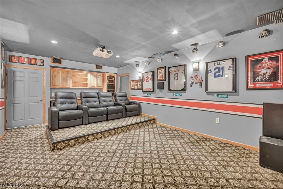 14353 Radcliffe Road Chardon, OH 44024 - Photo 39 of 50 Dedicated entertainment space featuring a patterned carpet floor, a raised seating platform, built-in cabinetry, and integrated ceiling lighting