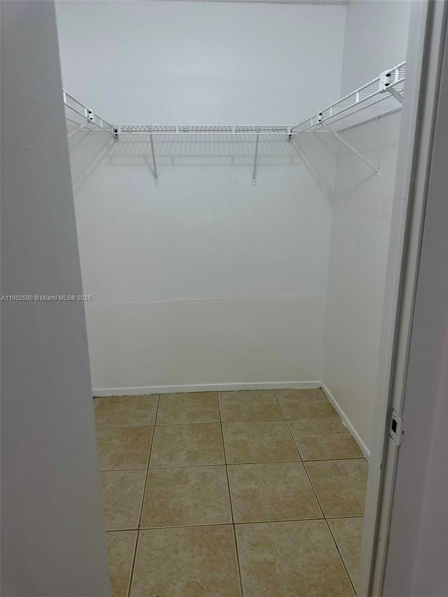 10581 Southwest 155th Court, Unit 1214 Miami, FL 33196 - Photo 15 of 35 a view of a room with racks on the wall