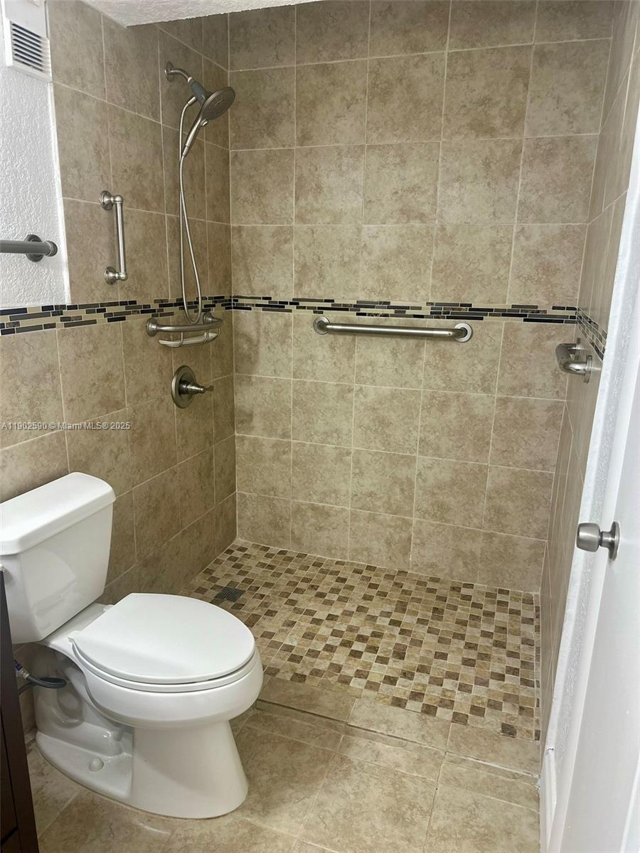 10581 Southwest 155th Court, Unit 1214 Miami, FL 33196 - Photo 17 of 35 a bathroom with a toilet and a shower