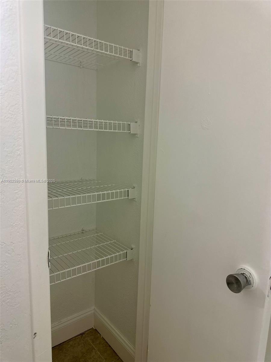 10581 Southwest 155th Court, Unit 1214 Miami, FL 33196 - Photo 24 of 35 a bathroom with a glass shower door