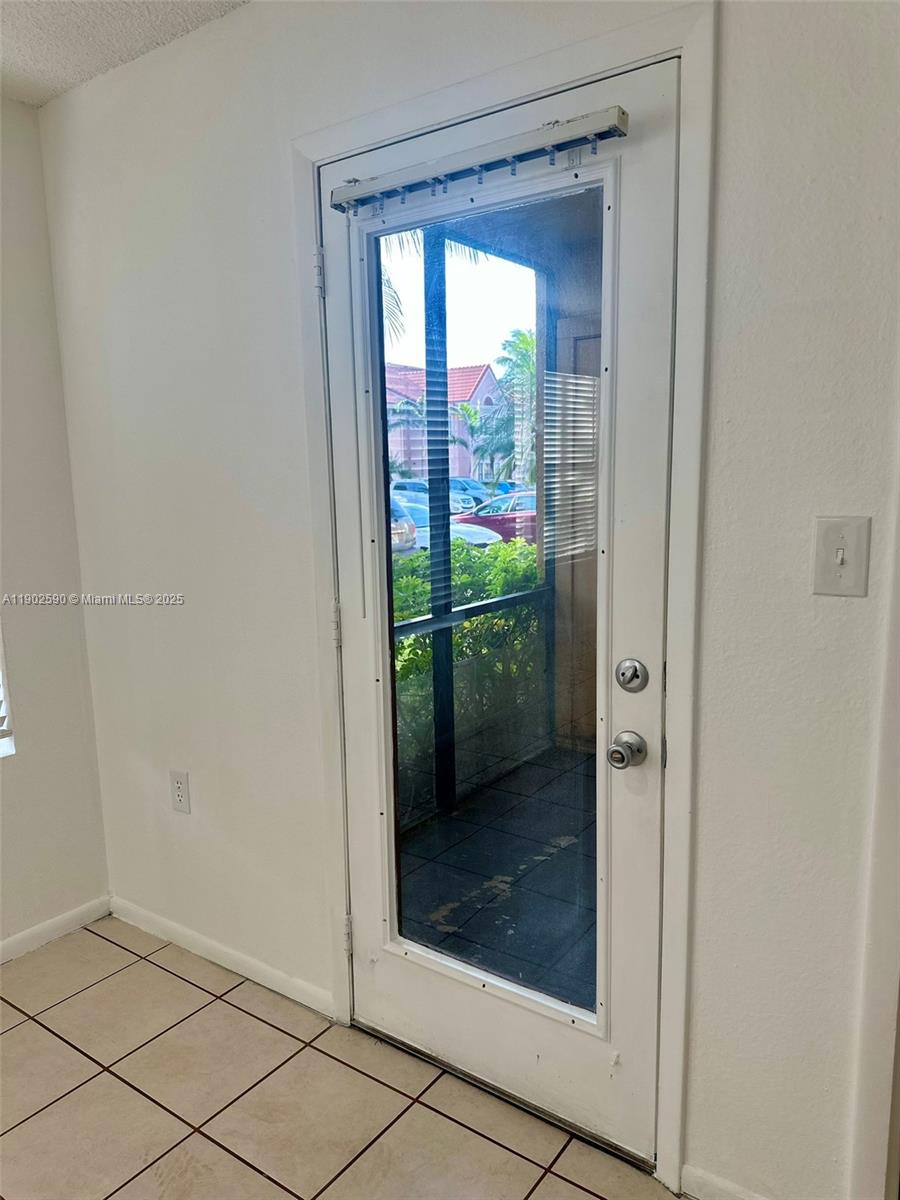 10581 Southwest 155th Court, Unit 1214 Miami, FL 33196 - Photo 25 of 35 a view of a glass door and a living room