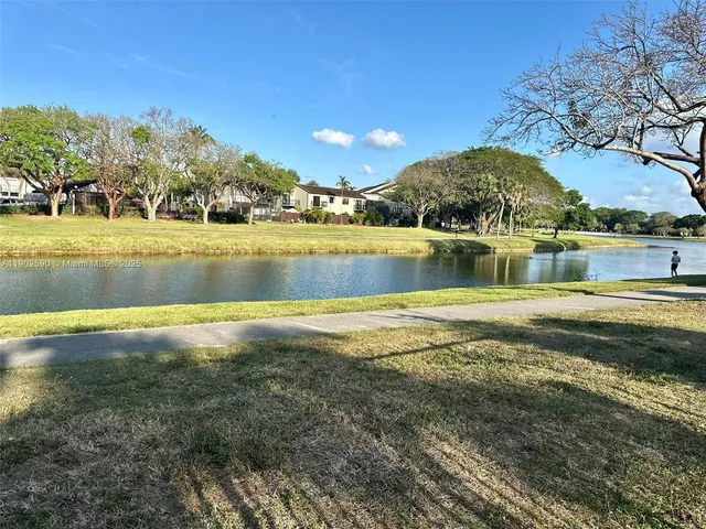 a view of a street with brick wall in front of it