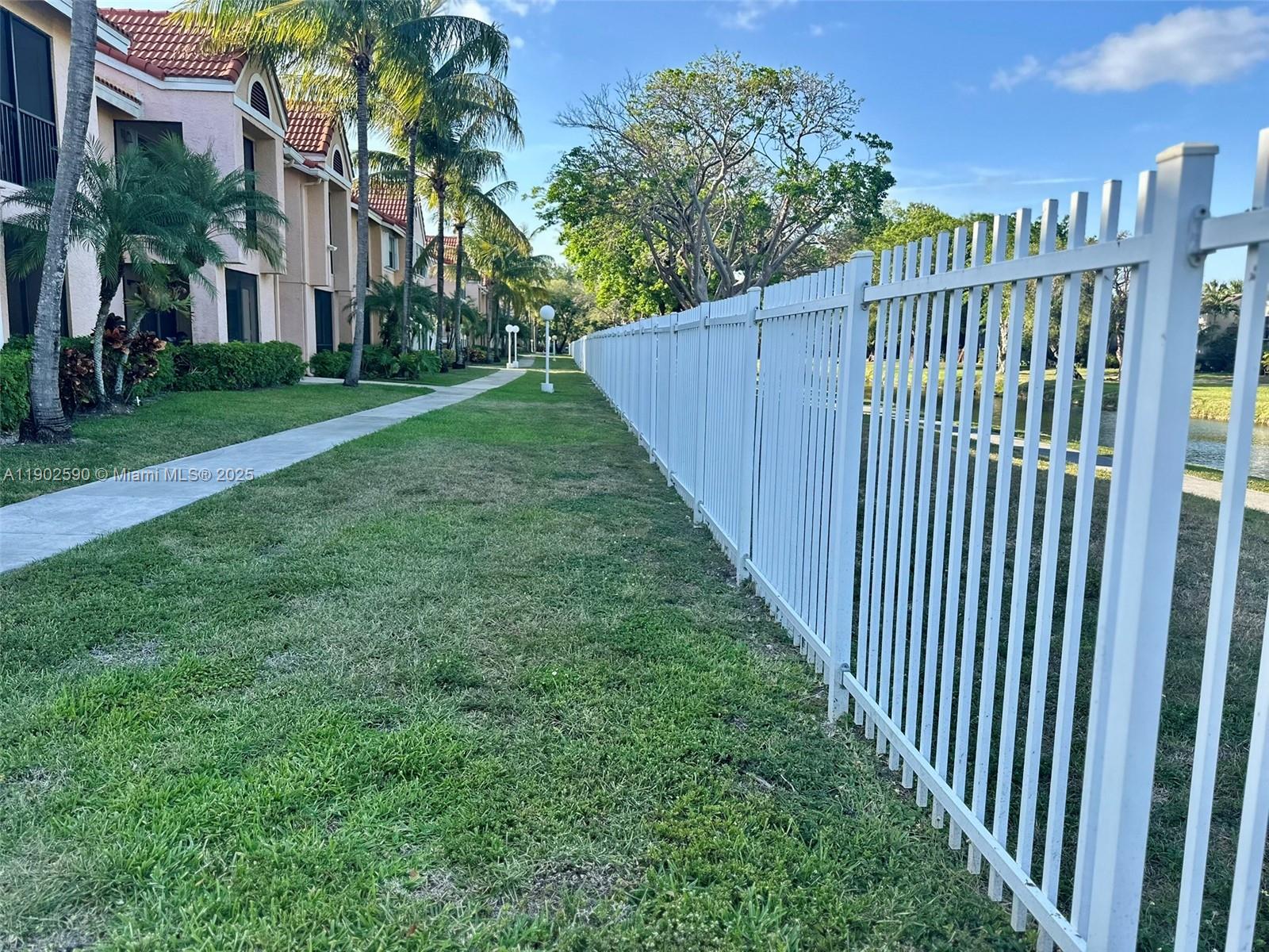 10581 Southwest 155th Court, Unit 1214 Miami, FL 33196 - Photo 32 of 35 a view of a street with brick wall in front of it