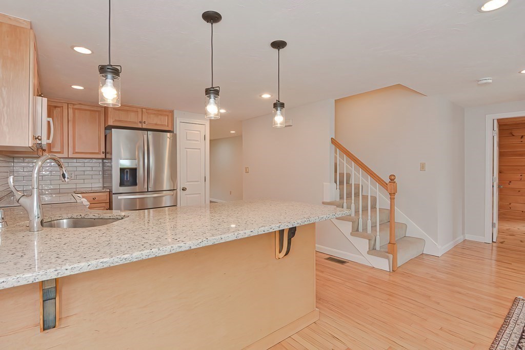 3 Zina Road Hudson, MA 01749 - Photo 13 of 41 a kitchen with stainless steel appliances granite countertop a sink a counter top space and cabinets