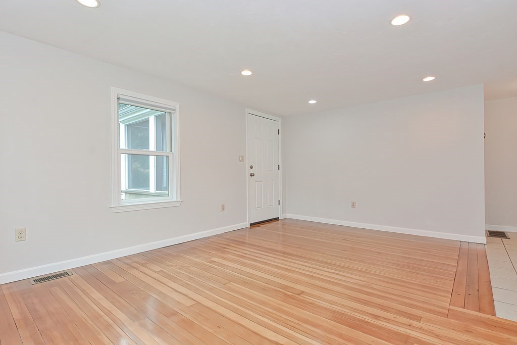 3 Zina Road Hudson, MA 01749 - Photo 7 of 41 a view of an empty room with wooden floor and a window