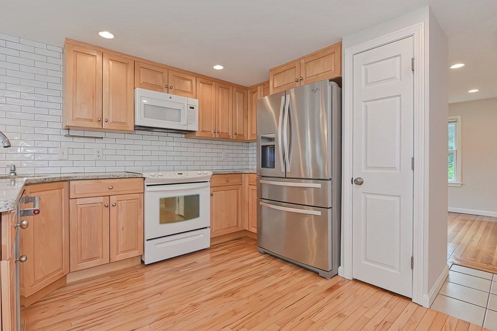3 Zina Road Hudson, MA 01749 - Photo 10 of 41 a kitchen with stainless steel appliances granite countertop a refrigerator and a stove top oven