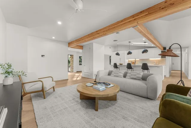 a living room with furniture and a large mirror