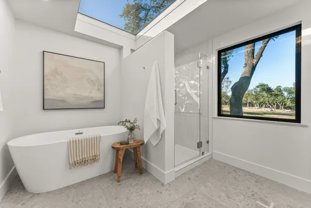 a bathroom with a bathtub and a shower