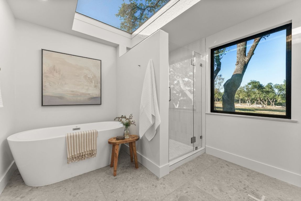 8717 South View Road Austin, TX 78737 - Photo 18 of 38 a bathroom with a bathtub and a shower
