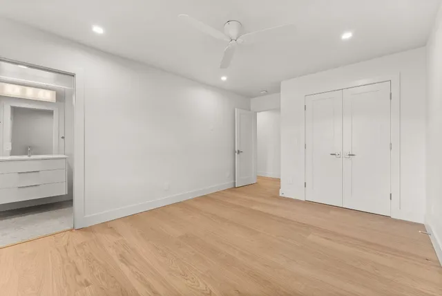 an empty room with closet and a bathroom