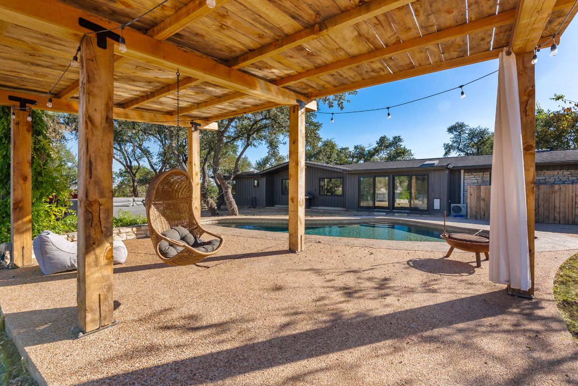 8717 South View Road Austin, TX 78737 - Photo 27 of 38 a view of a patio with a table and chairs
