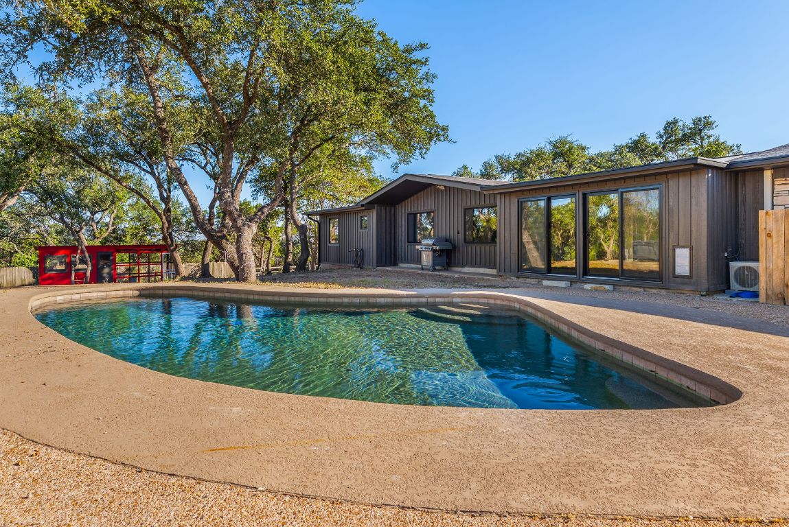 8717 South View Road Austin, TX 78737 - Photo 29 of 38 a view of a house with a swimming pool