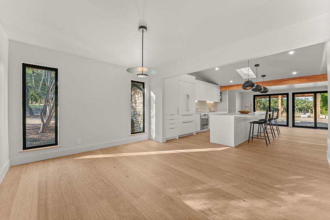 8717 South View Road Austin, TX 78737 - Photo 4 of 38 a view of a kitchen with furniture and floor to ceiling window