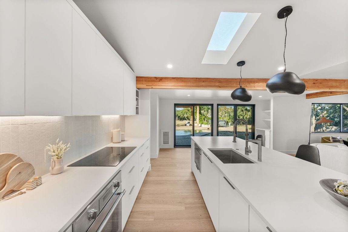 8717 South View Road Austin, TX 78737 - Photo 5 of 38 a large white kitchen with a large window