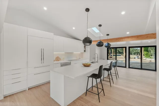 a view of a kitchen with furniture and a large window