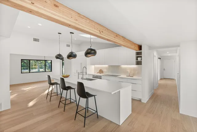 a kitchen with a table and chairs in it