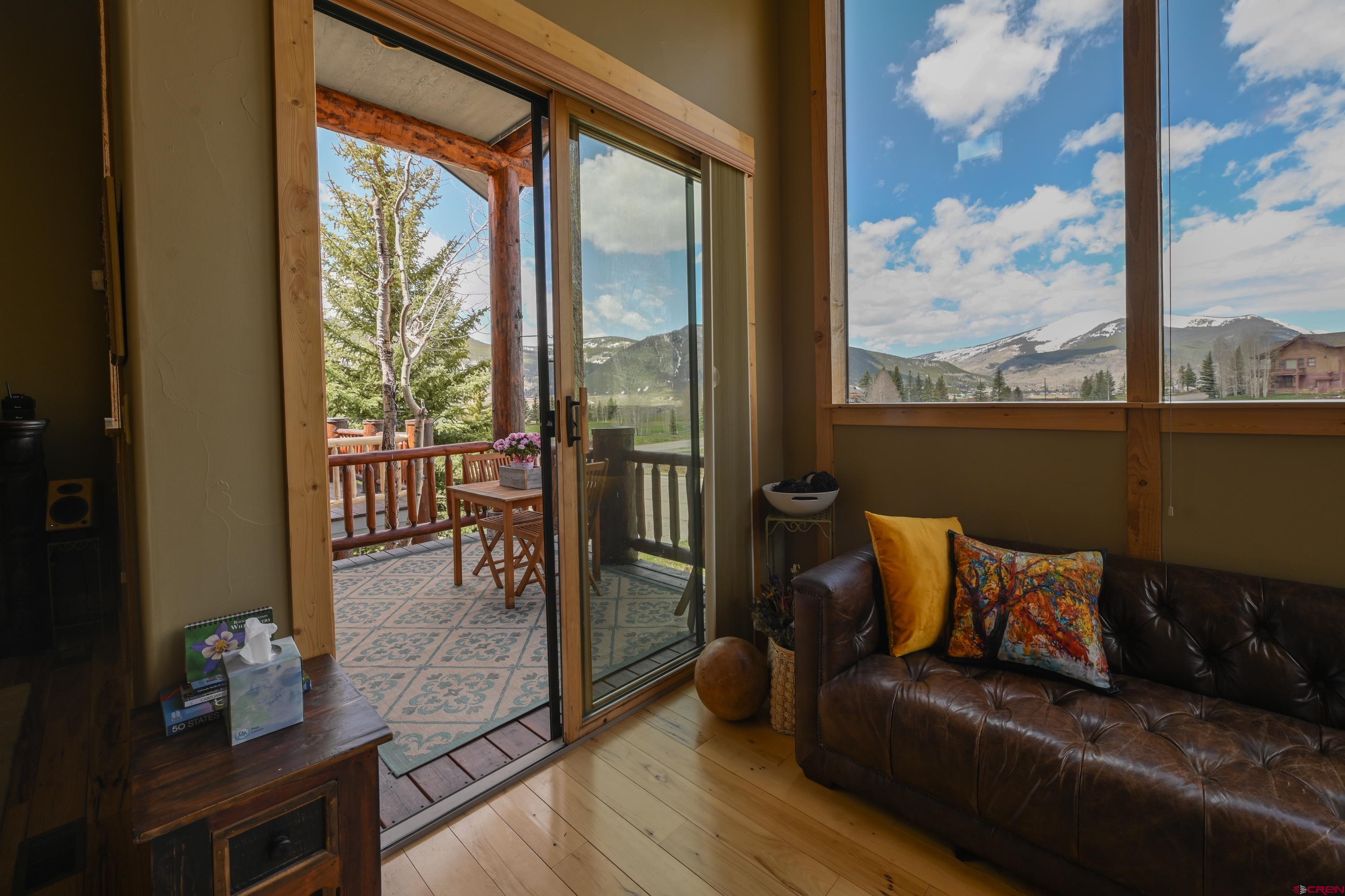 32 St Andrew's Circle Crested Butte, CO 81224 - Photo 15 of 35 a living room with furniture and a floor to ceiling window