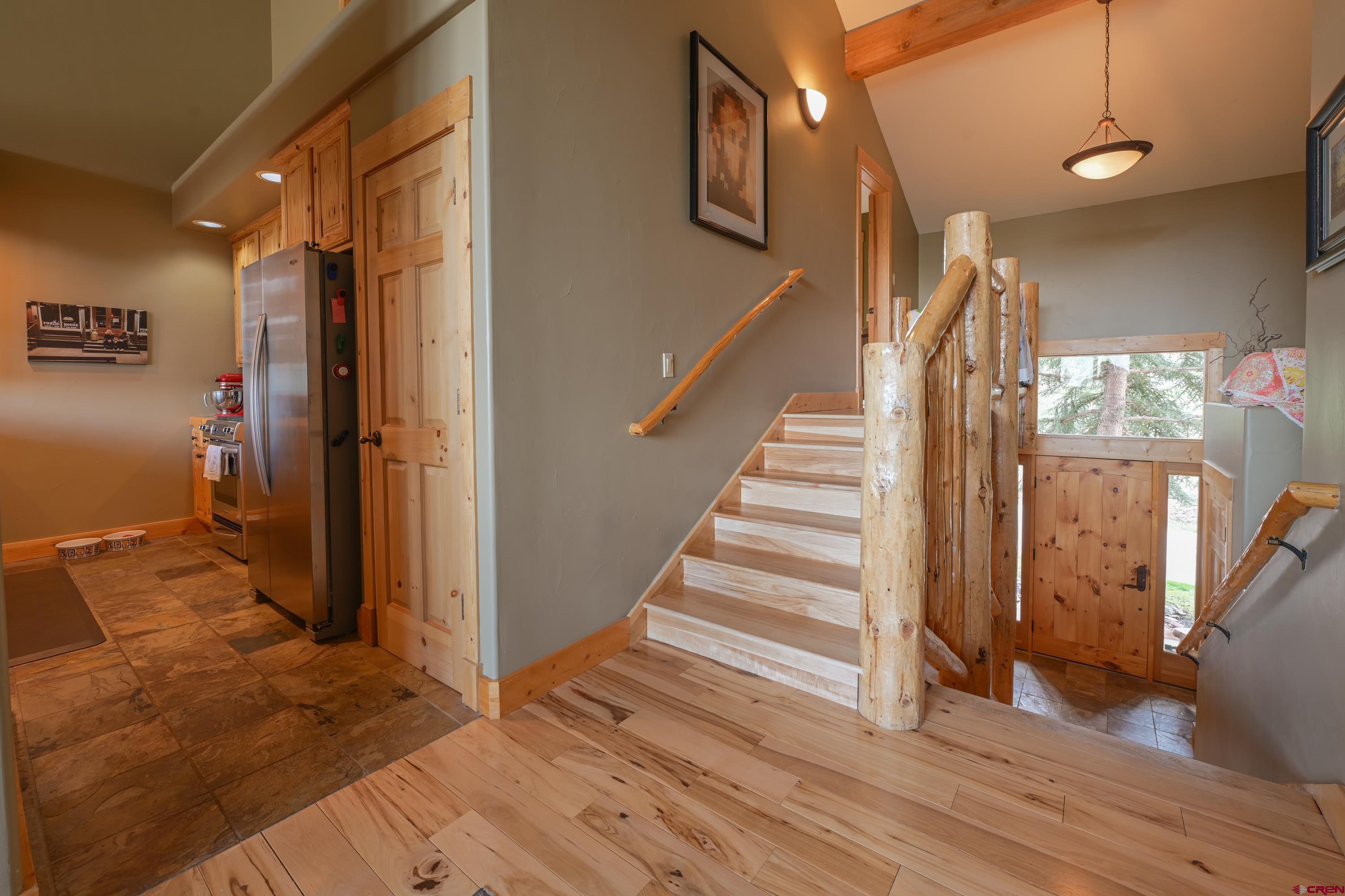 32 St Andrew's Circle Crested Butte, CO 81224 - Photo 10 of 35 a view of a hallway with wooden floor and staircase