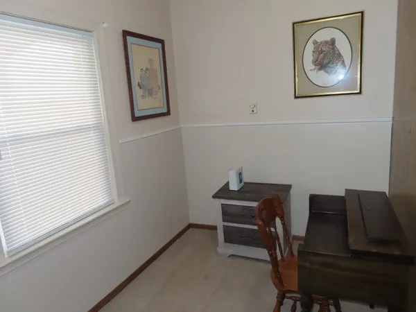 a view of a workspace with furniture and a window