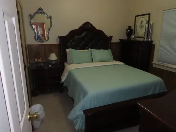 a bedroom with a bed and a television