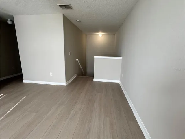 a view of a room with wooden floor