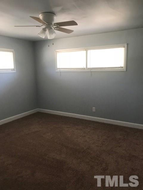 2901 North New Hope Road Raleigh, NC 27604 - Photo 7 of 13 en empty room with windows and fan