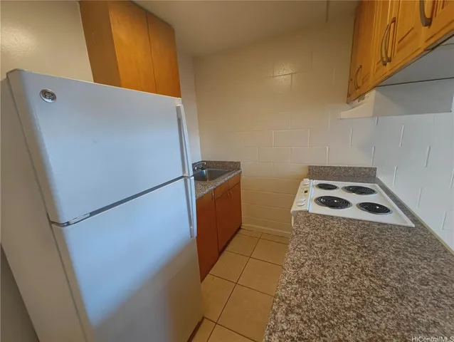 a view of a storage and utility room with washer and dryer