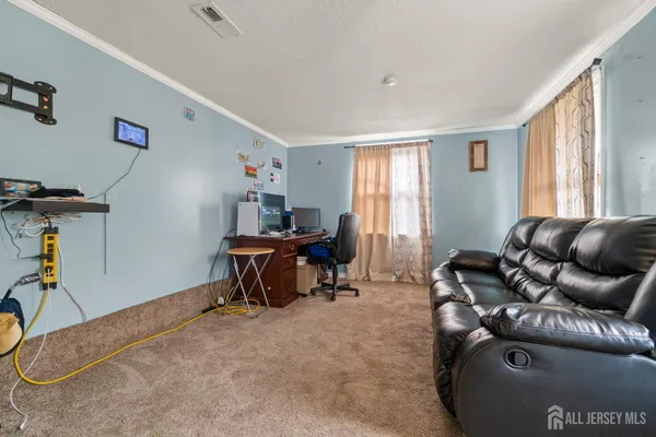 a living room with furniture a window and gym equipment