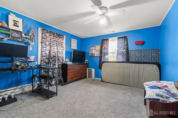 a bedroom with furniture and a flat screen tv