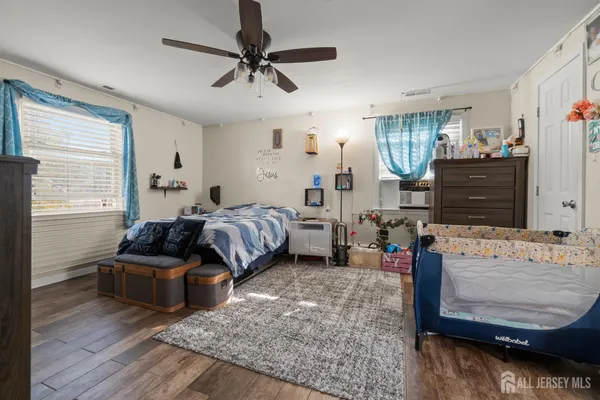 a bedroom with furniture and wooden floor