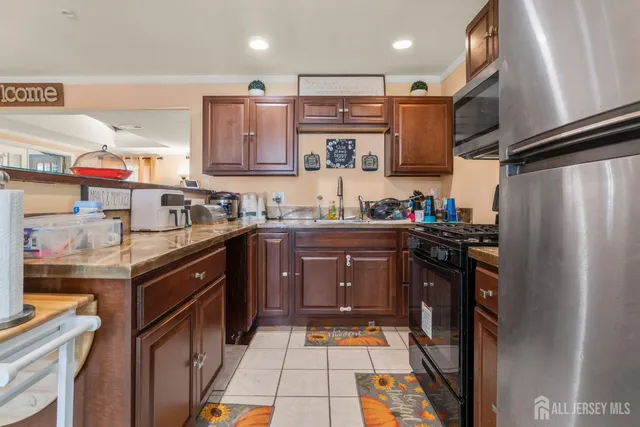 a kitchen with stainless steel appliances granite countertop a refrigerator and a sink