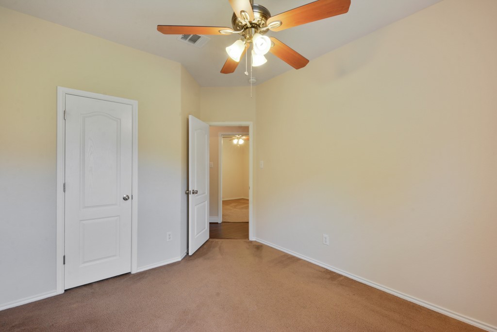 291 Cold Spring Buda, TX 78610 - Photo 18 of 25 an empty room with a fan and a fan