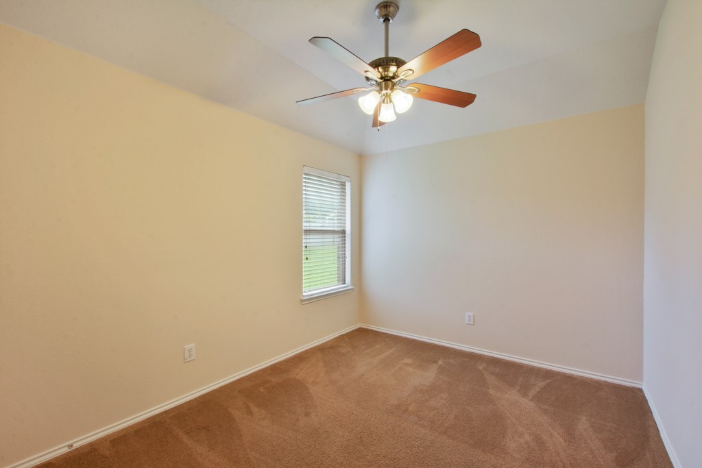 291 Cold Spring Buda, TX 78610 - Photo 19 of 25 an empty room with windows and fan