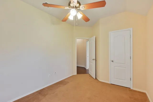 a view of a chandelier fan and closet in a room