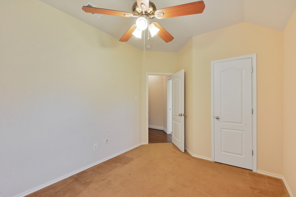 291 Cold Spring Buda, TX 78610 - Photo 20 of 25 a view of a chandelier fan and closet in a room