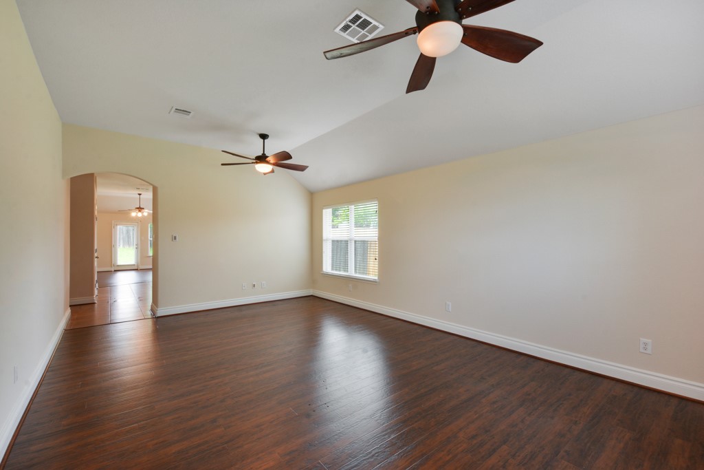 291 Cold Spring Buda, TX 78610 - Photo 2 of 25 an empty room with wooden floor ceiling fan and window