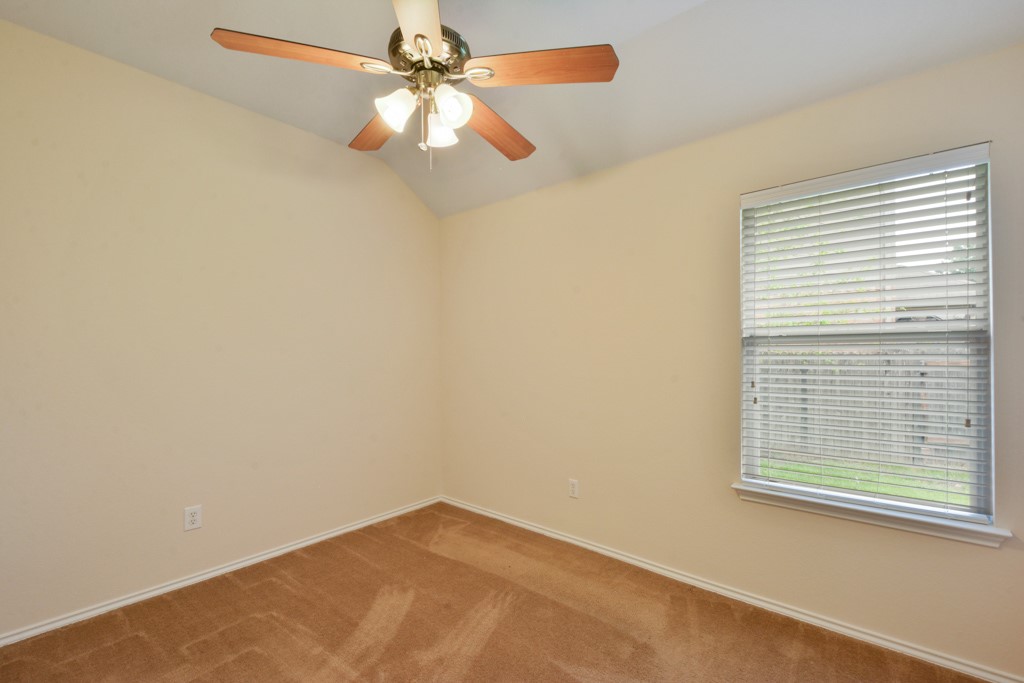291 Cold Spring Buda, TX 78610 - Photo 21 of 25 an empty room with a window and a fan