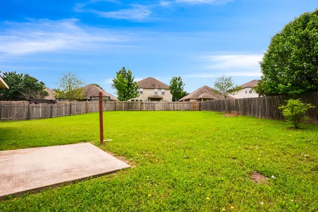 a view of a house with a backyard
